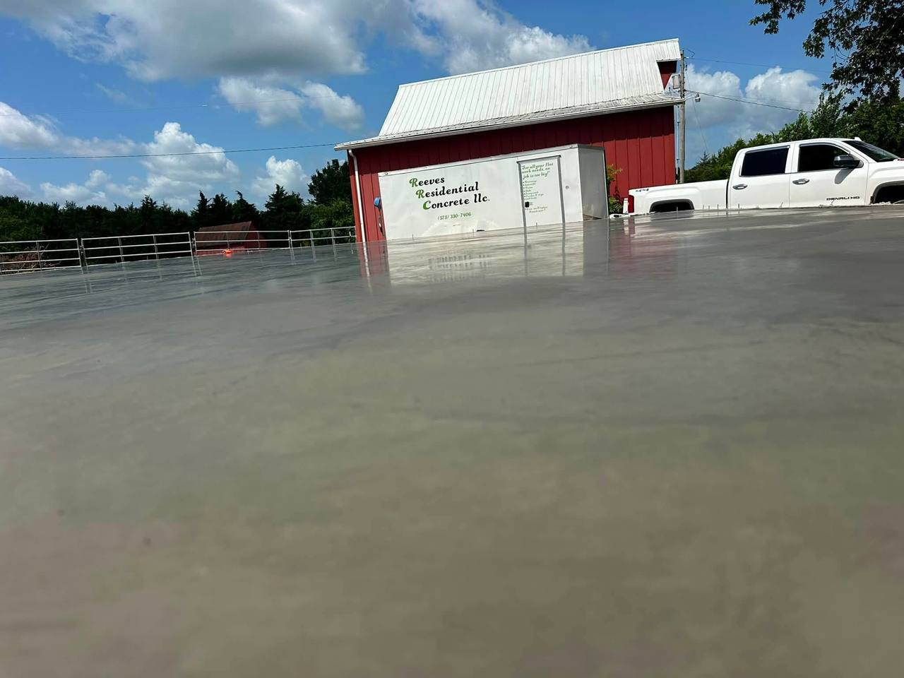 Fresh slab with the Reeves Residential Concrete trailer parked by a red barn