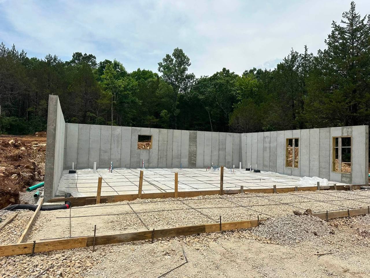 Poured concrete foundation walls with slab prep underway