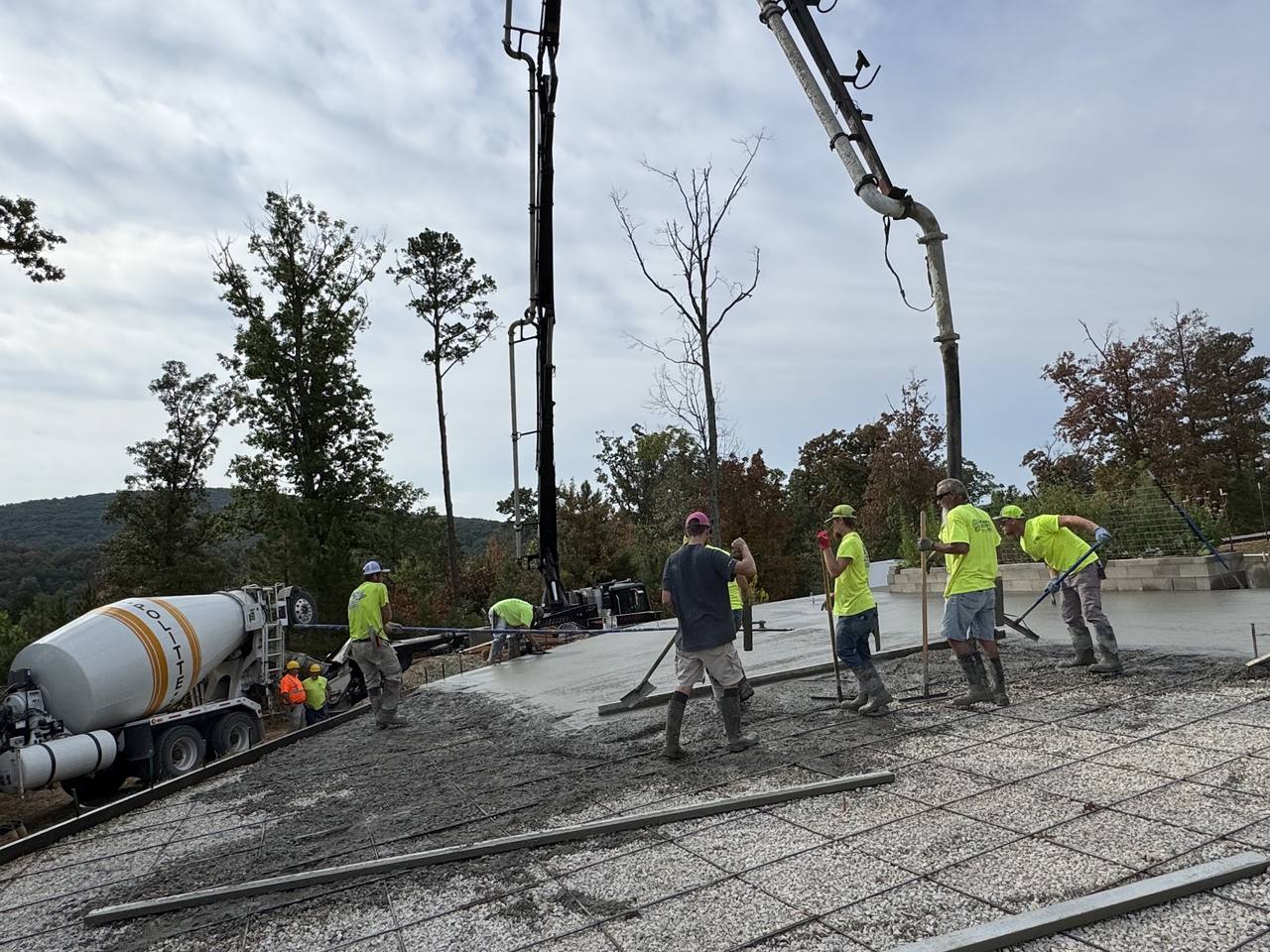 Boom pump pour with the crew screeding a large pad