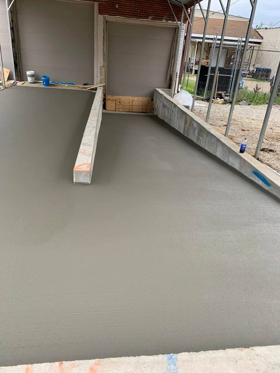 Fresh broom finished concrete ramp between two buildings